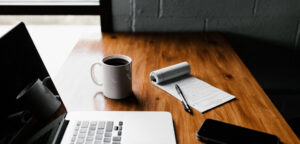 laptop on desk with coffee mug | edge accounting